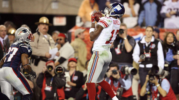 Feb 3, 2008; Glendale, AZ, USA; New York Giants wide receiver Plaxico Burress (17) catches the game-winning touchdown as New England Patriots cornerback Ellis Hobbs (27) defends in the fourth quarter during Super Bowl XLII at the University of Phoenix Stadium.  The New York Giants defeated the New England Patriots 17-14.  