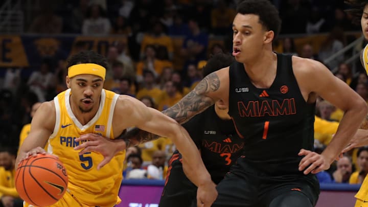 Feb 15, 2025; Pittsburgh, Pennsylvania, USA; Pittsburgh Panthers guard Ishmael Leggett (5) dribbles the ball against Miami (Fl) Hurricanes center Lynn Kidd (1) during the first half at the Petersen Events Center. Mandatory Credit: Charles LeClaire-Imagn Images