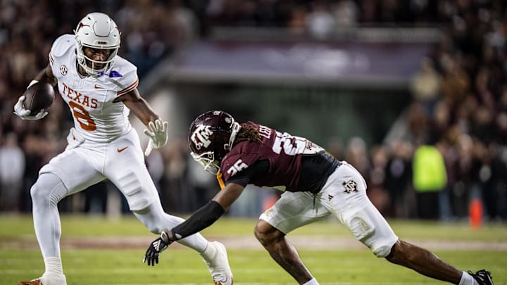 Texas Longhorns tight end Amari Niblack runs with the ball, bracing for a tackle from Texas A&M Aggies defensive back Will Lee III Texas Longhorns tight end Amari Niblack runs with the ball, bracing for a tackle from Texas A&M Aggies defensive back Will Lee III