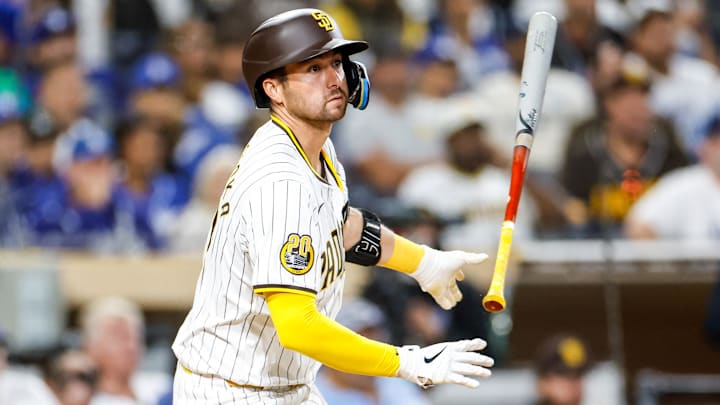 Jul 30, 2024; San Diego, California, USA; San Diego Padres catcher Kyle Higashioka (20) throws his bat after hitting a single during the fifth inning against the Los Angeles Dodgers at Petco Park