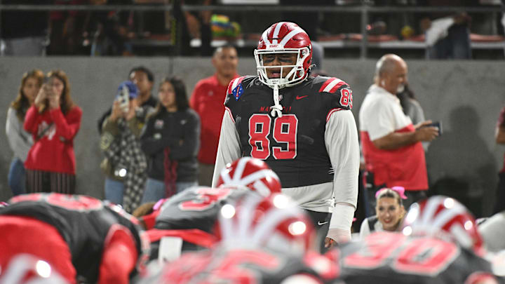 Mater Dei DL Semi Taulanga leads the Monarchs in pregame exercises before the Monarchs' 59-14 win over St. John Bosco at Santa Ana Stadium on Oct. 25, 2024.