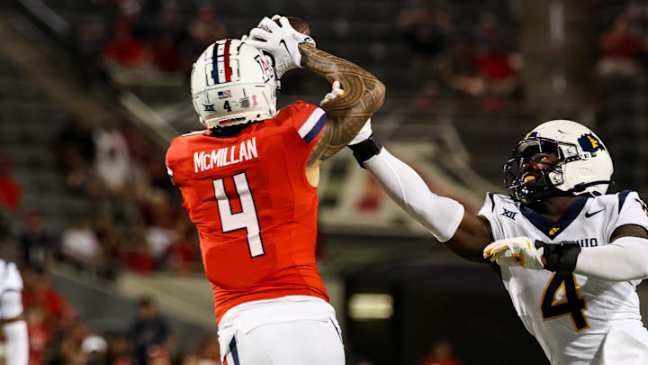 Oct 26, 2024; Tucson, Arizona, USA; Arizona Wildcats wide receiver Tetairoa McMillan (4) catches a long pass while West Virginia Mountaineers linebacker Trey Lathan (4) fails to defend against him during the fourth quarter at Arizona Stadium. Mandatory Credit: Aryanna Frank-Imagn Images Oct 26, 2024; Tucson, Arizona, USA; Arizona Wildcats wide receiver Tetairoa McMillan (4) catches a long pass while West Virginia Mountaineers linebacker Trey Lathan (4) fails to defend against him during the fourth quarter at Arizona Stadium. Mandatory Credit: Aryanna Frank-Imagn Images