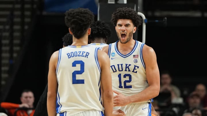 Mar 21, 2026; Greenville, SC, USA;  Duke Blue Devils forward Cameron Boozer (12) reacts with guard Cayden Boozer (2) in the second half during a second round game of the men's 2026 NCAA Tournament at Bon Secours Wellness Arena.