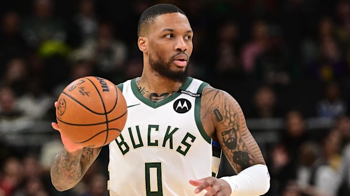 Mar 13, 2025; Milwaukee, Wisconsin, USA: Milwaukee Bucks guard Damian Lillard (0) dribbles the ball against the Los Angeles Lakers in the first quarter at Fiserv Forum. The Bucks wore a small patch to honor former player Junior Bridgeman who passed away this week.  Mandatory Credit: Benny Sieu-Imagn Images
