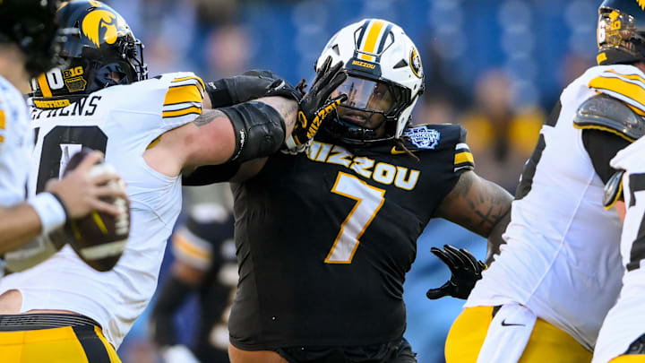 Dec 30, 2024; Nashville, TN, USA;  Missouri Tigers defensive tackle Chris McClellan (7) rushes Iowa Hawkeyes quarterback Brendan Sullivan (1) during the first half at Nissan Stadium. Mandatory Credit: Steve Roberts-Imagn Images