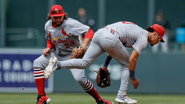Jul 23, 2025; Denver, Colorado, USA; St. Louis Cardinals second baseman Brendan Donovan (33) fields the ball behind shortstop Masyn Winn (0) in the seventh inning against the Colorado Rockies at Coors Field. Mandatory Credit: Isaiah J. Downing-Imagn Images