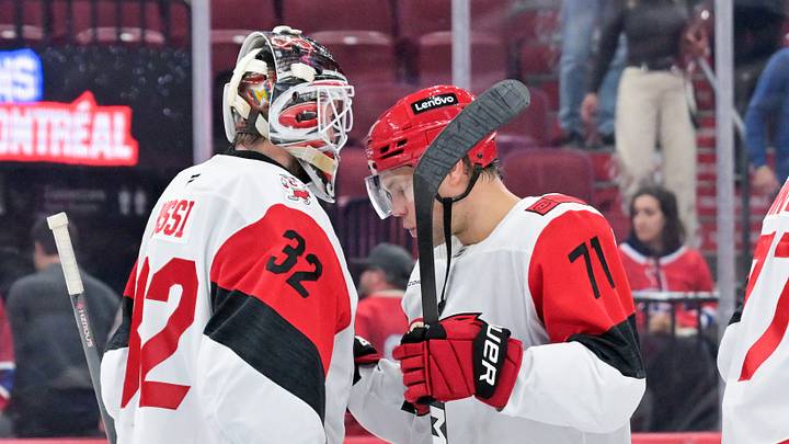 Oct 6, 2026; Montreal, Quebec, CAN;  Carolina Hurricanes goalie Brandon Bussi (32) and teammate forward Taylor Hall (71) celebrate the win against the Montreal Canadiens at the Bell Centre.  Mandatory Credit: Eric Bolte-Imagn Images