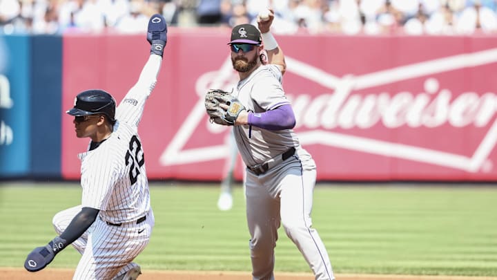 Aug 24, 2024; Bronx, New York, USA;  Colorado Rockies second baseman Brendan Rodgers (7) throws past New York Yankees right fielder Juan Soto (22) attempting to complete a double play in the first inning at Yankee Stadium. Mandatory Credit: Wendell Cruz-Imagn Images