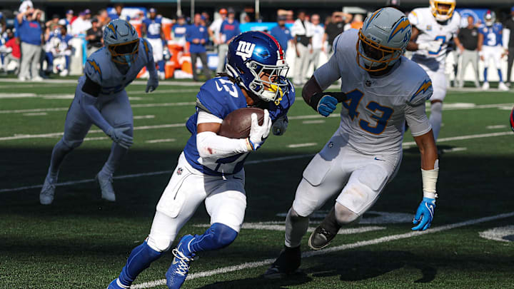 Sep 28, 2025; East Rutherford, New Jersey, USA; New York Giants wide receiver Wan'Dale Robinson (17) gains yards after catch as Los Angeles Chargers linebacker Troy Dye (43) pursues during the second half at MetLife Stadium. Mandatory Credit: Vincent Carchietta-Imagn Images