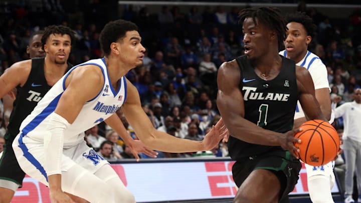 Feb 11, 2024; Memphis, Tennessee, USA; Tulane Green Wave guard Sion James (1) drives to the basket as Memphis Tigers forward Nicholas Jourdain (2) defends during the second half at FedExForum. Feb 11, 2024; Memphis, Tennessee, USA; Tulane Green Wave guard Sion James (1) drives to the basket as Memphis Tigers forward Nicholas Jourdain (2) defends during the second half at FedExForum.