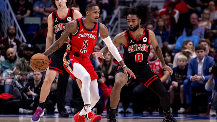 Oct 23, 2024; New Orleans, Louisiana, USA;  New Orleans Pelicans guard Dejounte Murray (5) dribbles against Chicago Bulls guard Coby White (0) during the first half at Smoothie King Center.