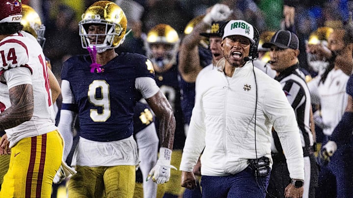 Oct 18, 2025; South Bend, Indiana, USA; Notre Dame Fighting Irish head coach Marcus Freeman and the  defense celebrates a turnover on downs in second half against the Southern California Trojans at Notre Dame Stadium. Mandatory Credit: Trevor Ruszkowski-Imagn Images