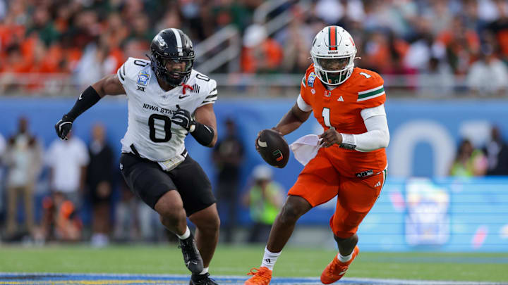 Dec 28, 2024; Orlando, FL, USA; Miami Hurricanes quarterback Cam Ward (1) runs with the ball against the Iowa State Cyclones in the second quarter during the Pop Tarts bowl at Camping World Stadium. Mandatory Credit: Nathan Ray Seebeck-Imagn Images
