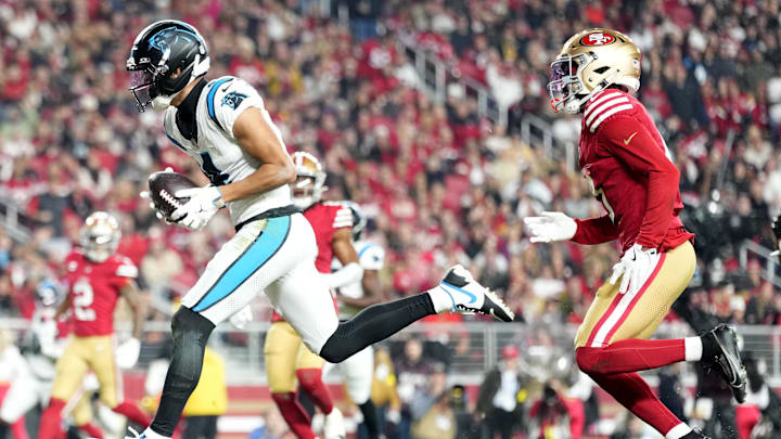 Nov 24, 2025; Santa Clara, California, USA; Carolina Panthers wide receiver Tetairoa McMillan (4) makes a touchdown catch against San Francisco 49ers cornerback Renardo Green (0) during the second half at Levi's Stadium. Mandatory Credit: Kelley L Cox-Imagn Images