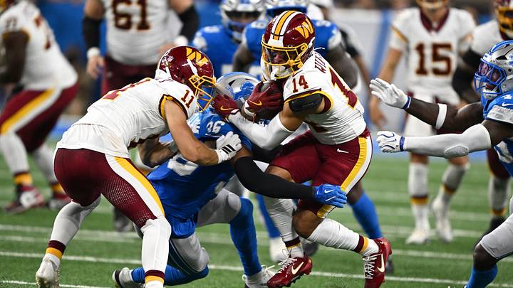Aug 22, 2026; Detroit, Michigan, USA;  Washington Commanders wide receiver Antonio Williams (14) is tackled by Detroit Lions safety Chuck Clark (36) after catching a pass in the second quarter at Ford Field.  Mandatory Credit: Lon Horwedel-Imagn Images