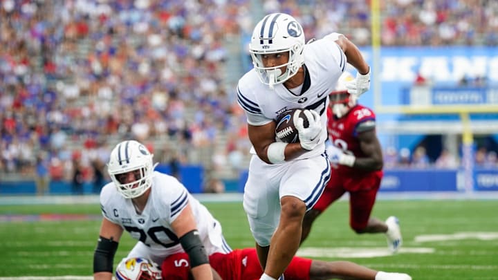 Sep 23, 2023; Lawrence, Kansas, USA; Brigham Young Cougars running back LJ Martin (27) runs for a touchdown against the Kansas Jayhawks during the first half at David Booth Kansas Memorial Stadium. Mandatory Credit: Jay Biggerstaff-Imagn Images Sep 23, 2023; Lawrence, Kansas, USA; Brigham Young Cougars running back LJ Martin (27) runs for a touchdown against the Kansas Jayhawks during the first half at David Booth Kansas Memorial Stadium. Mandatory Credit: Jay Biggerstaff-Imagn Images