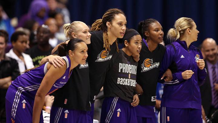 Sep 12, 2014; Chicago, IL, USA; Phoenix Mercury center Brittney Griner (middle) and teammates link arms as they watch during the fourth quarter against the Chicago Sky in game three of the 2014 WNBA Finals at UIC Pavilion. Mandatory Credit: Jerry Lai-Imagn Images
