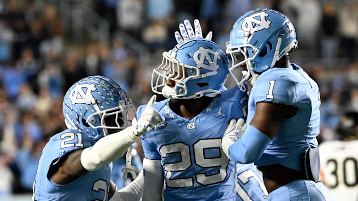 Nov 16, 2024; Chapel Hill, North Carolina, USA; North Carolina Tar Heels defensive back Marcus Allen (29) reacts with defensive backs Kaleb Cost (21) and Antavious Lane (1) after intercepting the ball in the third quarter at Kenan Memorial Stadium. Mandatory Credit: Bob Donnan-Imagn Images Nov 16, 2024; Chapel Hill, North Carolina, USA; North Carolina Tar Heels defensive back Marcus Allen (29) reacts with defensive backs Kaleb Cost (21) and Antavious Lane (1) after intercepting the ball in the third quarter at Kenan Memorial Stadium. Mandatory Credit: Bob Donnan-Imagn Images
