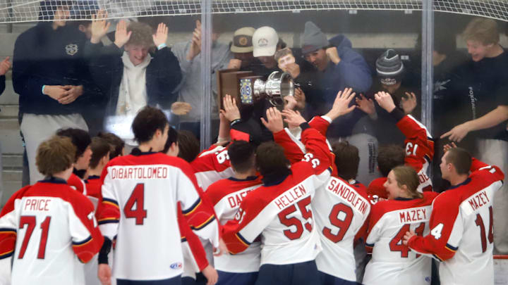 The Morgantown (W.Va.) Mohawks hockey team celebrates its first Penguins Cup championship with their fans Tuesday night at the UPMC Lemieux Complex. The Mohawks won the varsity Division 2 crown with a 5-1 win over Burrell. The Morgantown (W.Va.) Mohawks hockey team celebrates its first Penguins Cup championship with their fans Tuesday night at the UPMC Lemieux Complex. The Mohawks won the varsity Division 2 crown with a 5-1 win over Burrell.