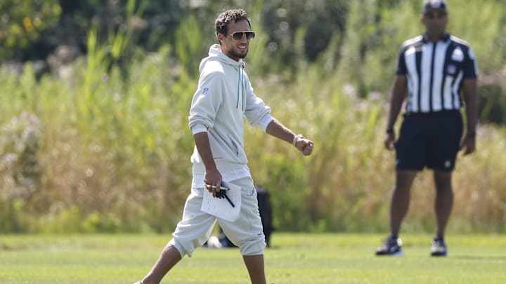 Mike McDaniel walks across Halas Hall's practice field prior to Bears-Dolphins joint practice. Mike McDaniel walks across Halas Hall's practice field prior to Bears-Dolphins joint practice.