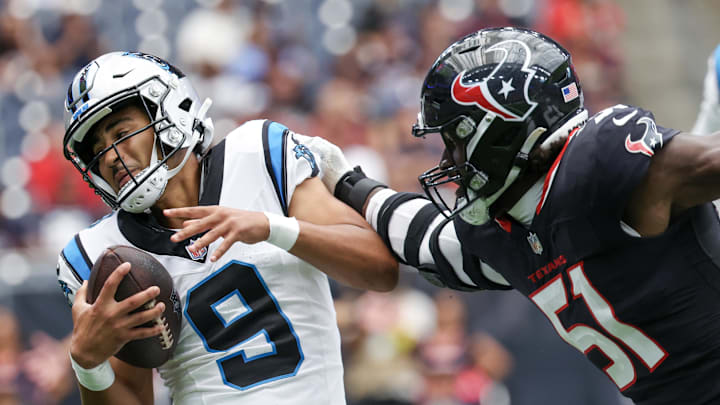 Aug 16, 2025; Houston, Texas, USA; Carolina Panthers quarterback Bryce Young (9) is tackled for a loss by Houston Texans defensive end Will Anderson Jr. (51) in the first quarter at NRG Stadium. Mandatory Credit: Thomas Shea-Imagn Images