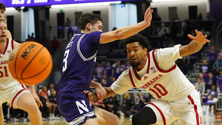 Nebraska guard Jamarques Lawrence passes around Northwestern guard Jake West during the first half at Welsh-Ryan Arena. 