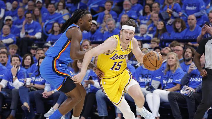 May 5, 2026; Oklahoma City, Oklahoma, USA; Los Angeles Lakers guard Austin Reaves (15) drives around Oklahoma City Thunder guard Cason Wallace (22) in the first half during game one of the second round of the 2026 NBA Playoffs at Paycom Center. Mandatory Credit: Alonzo Adams-Imagn Images