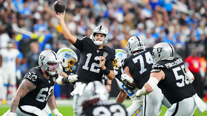 Jan 5, 2025; Paradise, Nevada, USA; Las Vegas Raiders quarterback Aidan O'Connell (12) makes a pass attempt against the Los Angeles Chargers during the fourth quarter at Allegiant Stadium. Mandatory Credit: Stephen R. Sylvanie-Imagn Images