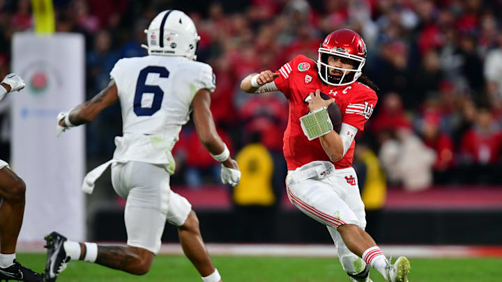 Utah Utes quarterback Cameron Rising (7) runs against Penn State Nittany Lions safety Zakee Wheatley (6) 