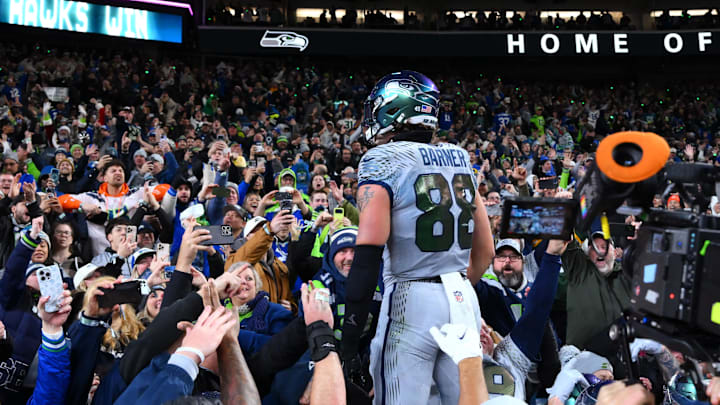 Dec 18, 2025; Seattle, Washington, USA; Seattle Seahawks tight end AJ Barner (88) celebrates with fans after a win against the Los Angeles Rams in overtime at Lumen Field.