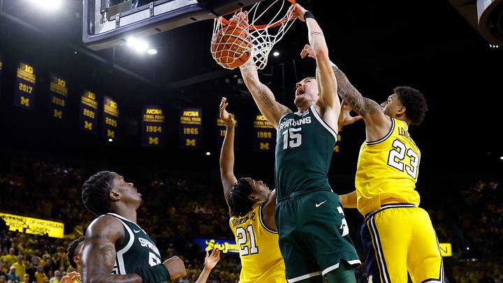 Mar 8, 2026; Ann Arbor, Michigan, USA;  Michigan State Spartans center Carson Cooper (15) dunks in the second half against Michigan Wolverines forward Morez Johnson Jr. (21) and forward Yaxel Lendeborg (23) at Crisler Center. Mandatory Credit: Rick Osentoski-Imagn Images