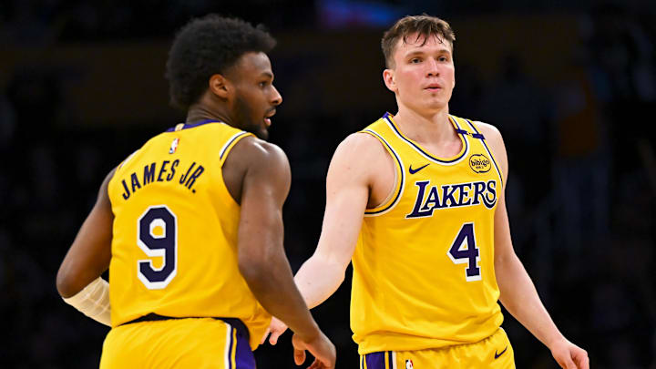 Mar 20, 2025; Los Angeles, California, USA; Los Angeles Lakers guard Dalton Knecht (4) fives guard Bronny James (9) after scoring against the Milwaukee Bucks during the second half at Crypto.com Arena. Mandatory Credit: Jonathan Hui-Imagn Images
