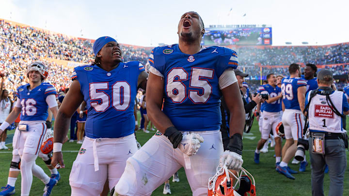 Nov 23, 2024; Gainesville, Florida, USA; Florida Gators offensive lineman Brandon Crenshaw-Dickson (65) celebrates with offensive lineman Jason Zandamela (50) after a game against the Mississippi Rebels at Ben Hill Griffin Stadium. Mandatory Credit: Matt Pendleton-Imagn Images Nov 23, 2024; Gainesville, Florida, USA; Florida Gators offensive lineman Brandon Crenshaw-Dickson (65) celebrates with offensive lineman Jason Zandamela (50) after a game against the Mississippi Rebels at Ben Hill Griffin Stadium. Mandatory Credit: Matt Pendleton-Imagn Images