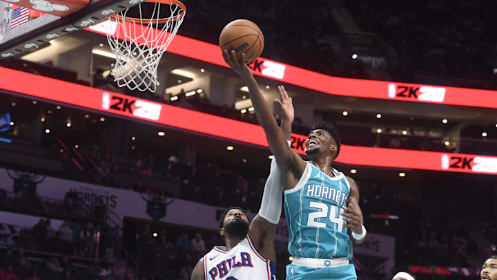 Dec 16, 2024; Charlotte, North Carolina, USA;  Charlotte Hornets forward Brandon Miller (24) drives past Philadelphia 76ers forward Paul George (8) during the second half at the Spectrum Center. Mandatory Credit: Sam Sharpe-Imagn Images