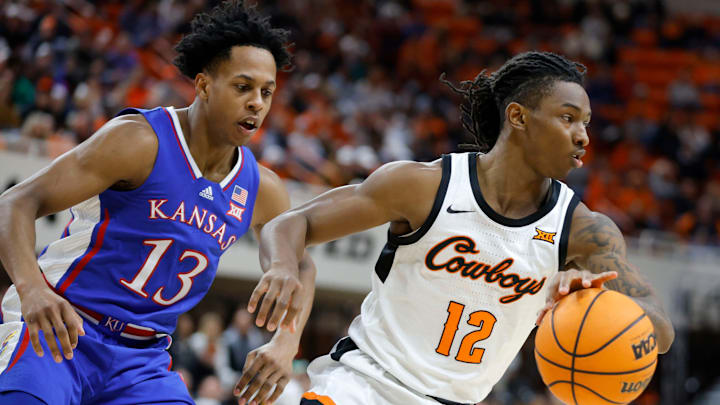 Oklahoma State Cowboys guard Javon Small (12) is defended by Kansas Jayhawks guard Elmarko Jackson (13) during a college basketball game between the Oklahoma State University Cowboys (OSU) and the Kansas Jayhawks at Gallagher-Iba Arena in Stillwater, Okla., Tuesday, Jan. 16, 2024. Oklahoma State Cowboys guard Javon Small (12) is defended by Kansas Jayhawks guard Elmarko Jackson (13) during a college basketball game between the Oklahoma State University Cowboys (OSU) and the Kansas Jayhawks at Gallagher-Iba Arena in Stillwater, Okla., Tuesday, Jan. 16, 2024.