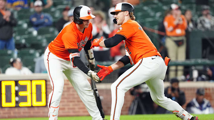 May 18, 2024; Baltimore, Maryland, USA; Baltimore Orioles catcher Adley Rutschman (35) congratulates shortstop Gunnar Henderson (2) for hitting a home run during the ninth inning against the Seattle Mariners at Oriole Park at Camden Yards.