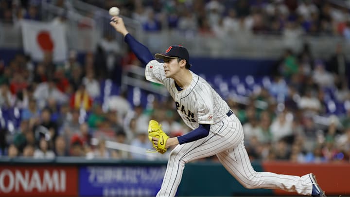 Mar 20, 2023; Miami, Florida, USA; Japan starting pitcher Roki Sasaki (14) delivers a pitch during the first inning against Mexico at LoanDepot Park. Mandatory Credit: Sam Navarro-Imagn Images