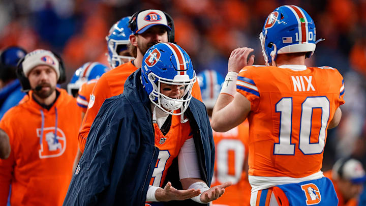 Jan 5, 2025; Denver, Colorado, USA; Denver Broncos quarterback Jarrett Stidham (8) celebrates with quarterback Bo Nix (10) after a play in the fourth quarter against the Kansas City Chiefs at Empower Field at Mile High. 