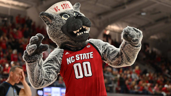 Mar 24, 2025; Raleigh, North Carolina, USA; The NC State Wolfpack mascot celebrates during the second half at James T. Valvano Arena at William Neal Reynolds. Mandatory Credit: William Howard-Imagn Images
