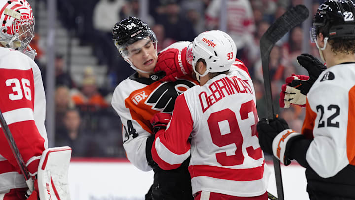 Apr 2, 2026; Philadelphia, Pennsylvania, USA; Philadelphia Flyers right wing Porter Martone (94) scuffles with Detroit Red Wings right wing Alex Debrincat (93) in the second period at Xfinity Mobile Arena. Mandatory Credit: Kyle Ross-Imagn Images