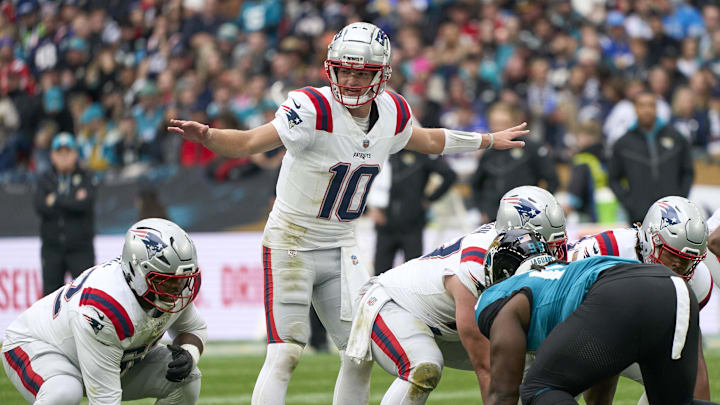 Oct 20, 2024; London, United Kingdom; New England Patriots quarterback Drake Maye signs to players in the first half.