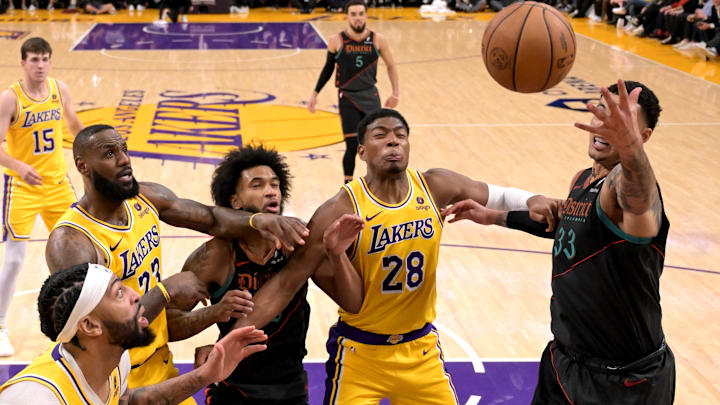 Feb 29, 2024; Los Angeles, California, USA;   Los Angeles Lakers forward LeBron James (23), Washington Wizards forward Marvin Bagley III (35), Los Angeles Lakers forward Rui Hachimura (28) and Washington Wizards forward Kyle Kuzma (33) battle for a rebound in the second half at Crypto.com Arena. Mandatory Credit: Jayne Kamin-Oncea-Imagn Images