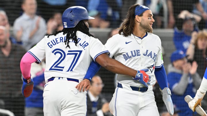 Apr 8, 2024; Toronto, Ontario, CAN;  Toronto Blue Jays first baseman Vladimir Guerrero Jr. (27) and shortstop Bo Bichette (11) celebrate after scoring against the Seattle Mariners in the third inning at Rogers Centre