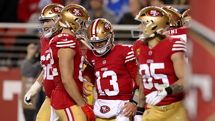 Dec 30, 2024; Santa Clara, California, USA; San Francisco 49ers quarterback Brock Purdy (13) is congratulated by teammates after scoring a touchdown during the second quarter against the Detroit Lions at Levi's Stadium. Mandatory Credit: Sergio Estrada-Imagn Images