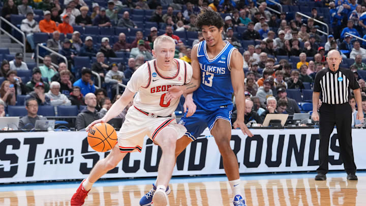 Mar 19, 2026; Buffalo, NY, USA; Georgia Bulldogs guard Blue Cain (0) drives to the basket against Saint Louis Billikens guard Dion Brown (13) during the second half of a first round game of the men's 2026 NCAA Tournament at Keybank Center. Mandatory Credit: Gregory Fisher-Imagn Images