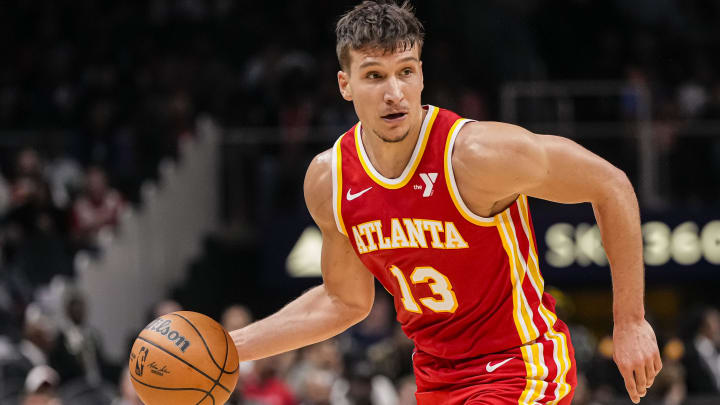 Apr 10, 2024; Atlanta, Georgia, USA; Atlanta Hawks guard Bogdan Bogdanovic (13) controls the ball against the Charlotte Hornets during the first half at State Farm Arena.