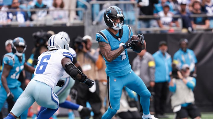 Oct 12, 2025; Charlotte, North Carolina, USA; Carolina Panthers wide receiver Tetairoa McMillan (4) makes a catch for a touchdown during the second half against the Dallas Cowboys at Bank of America Stadium. Mandatory Credit: Scott Kinser-Imagn Images