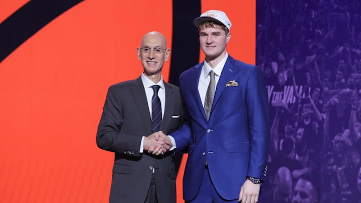 Jun 25, 2025; Brooklyn, NY, USA; Liam McNeeley stands with NBA commissioner Adam Silver after being selected as the 29th pick by the Phoenix Suns in the first round of the 2025 NBA Draft at Barclays Center. Mandatory Credit: Brad Penner-Imagn Images Jun 25, 2025; Brooklyn, NY, USA; Liam McNeeley stands with NBA commissioner Adam Silver after being selected as the 29th pick by the Phoenix Suns in the first round of the 2025 NBA Draft at Barclays Center. Mandatory Credit: Brad Penner-Imagn Images