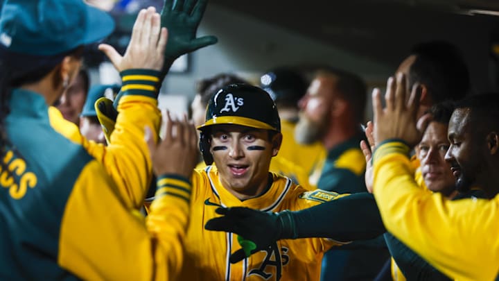 Mar 27, 2025; Seattle, Washington, USA; Athletics first baseman Tyler Soderstrom (21) celebrates in the dugout  after hitting a solo-home run against the Seattle Mariners during the fifth inning at T-Mobile Park. Mandatory Credit: Joe Nicholson-Imagn Images