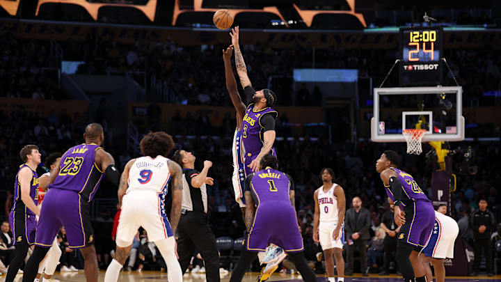 Mar 22, 2024; Los Angeles, California, USA;  Los Angeles Lakers forward Anthony Davis (3) and Philadelphia 76ers center Mo Bamba (5) tip off during the first quarter at Crypto.com Arena. Mandatory Credit: Kiyoshi Mio-Imagn Images